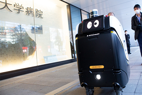 2台の5G自動配送ロボットが西新宿を快走！フードデリバリーと医薬品配送の自動化をめざす　川崎重工/KDDI/タケダ等6社が共同で