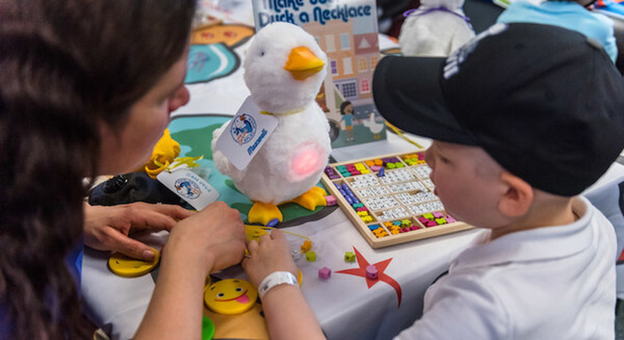 <p>Maxwell, a 4-year-old cancer patient, creates a personalized necklace for his new friend, My Special Aflac Duck, following a fun scavenger hunt at Childrenís Hospital in New Orleans on Thursday, Nov. 29, 2018. Aflac, a long-time supporter of children and families facing childhood cancer, hosted a special delivery event for several children at the hospital to debut the companyís new robotic, caring companion for children coping with cancer.</p>