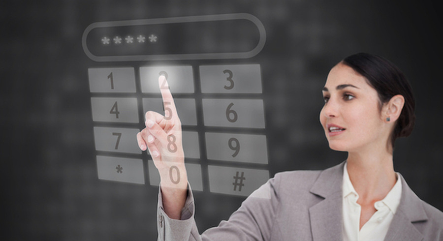 <p>Businesswoman using touch screen against a black background</p>