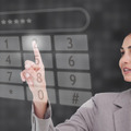 <p>Businesswoman using touch screen against a black background</p>