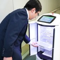 日本オーチス、大分県庁で自動搬送ロボットとのエレベータ連携実証に成功　県庁内で郵便物や小包を自動搬送、顔認証も活用